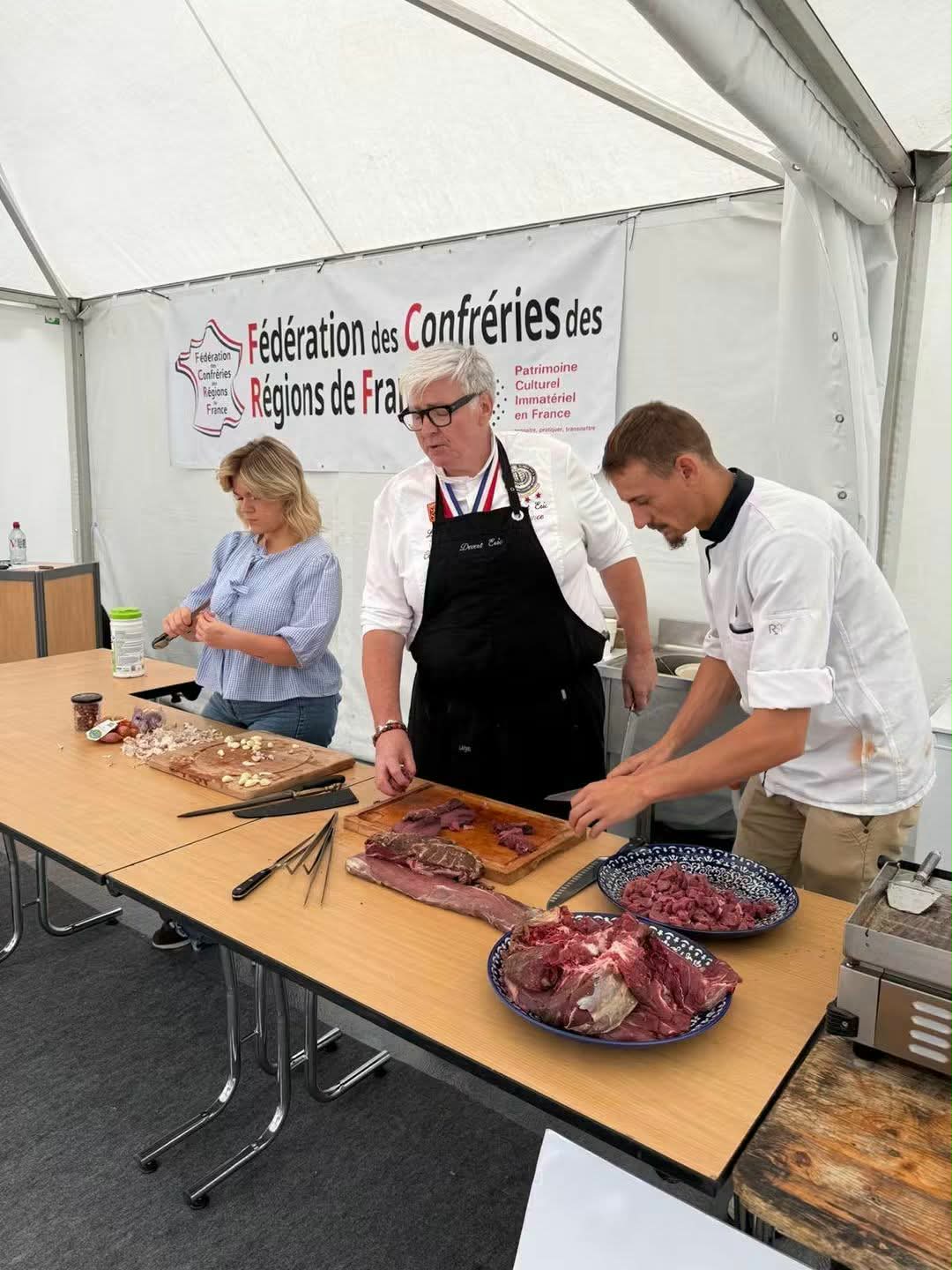 Culinary demonstration with regional meats at the Fédération des Confréries des Régions de France stand